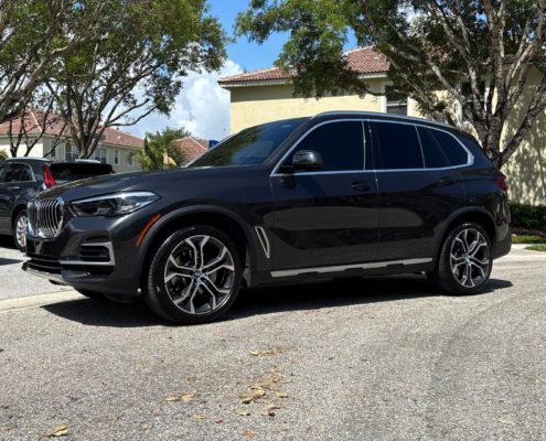 BMW SUV BMW SUV with a sleek, reflective finish after professional detailing in Palm Beach County.