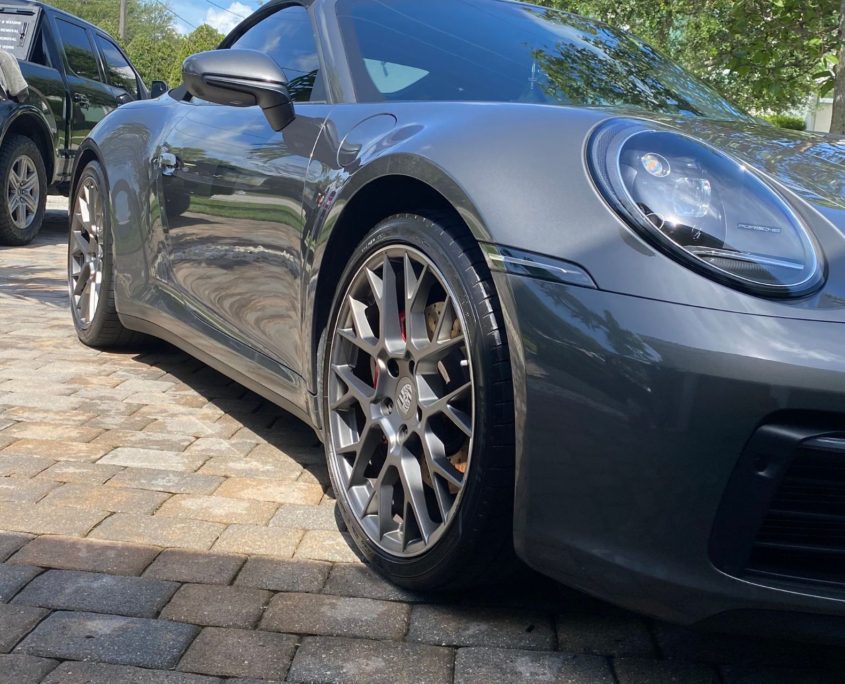 Gray Porsche Gray Porsche with a sleek, reflective finish after professional detailing in Palm Beach County.