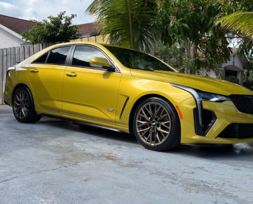 Mustard Yellow Metallic Cadillac Mustard yellow metallic Cadillac with a brilliant reflective finish after professional detailing in Palm Beach County.